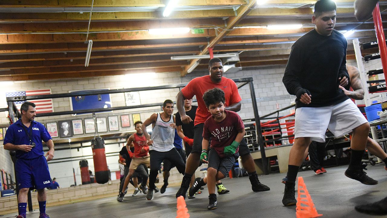 Coaches and young boxers doing footwork drills at Barry's Boxing Center